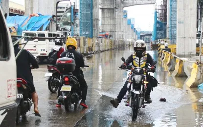 image of rain and thunderstorms trigger flooding in metro manila
